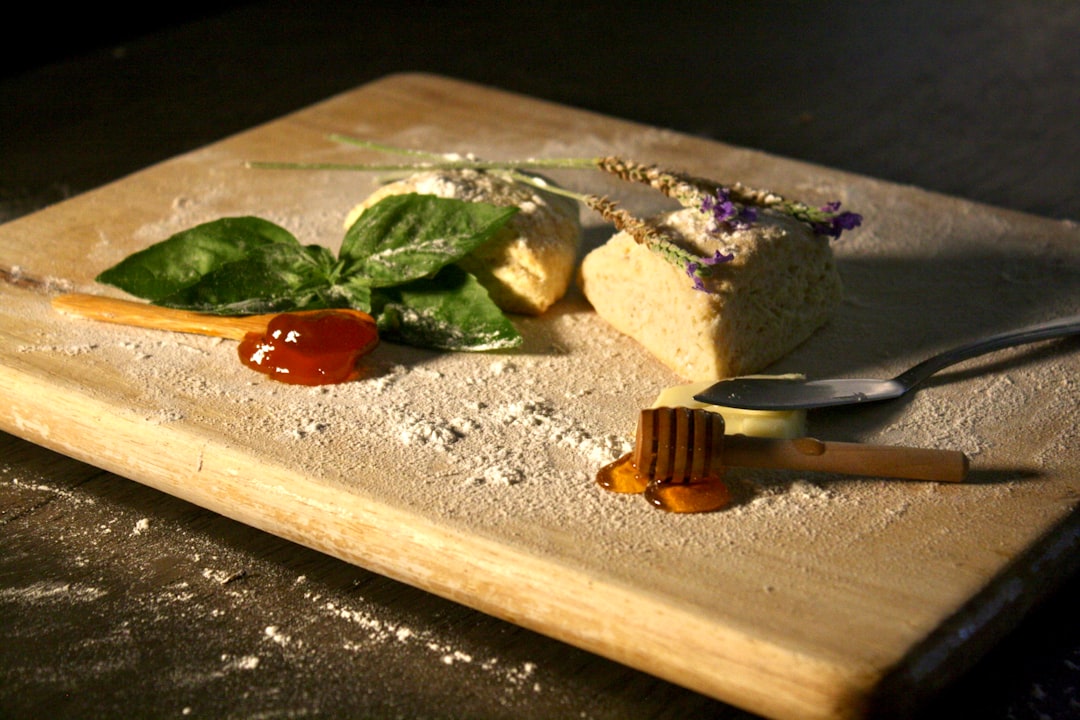 Beautifully plated blackberry basil ricotta pizza with fresh herbs and drizzled balsamic glaze on rustic wooden board