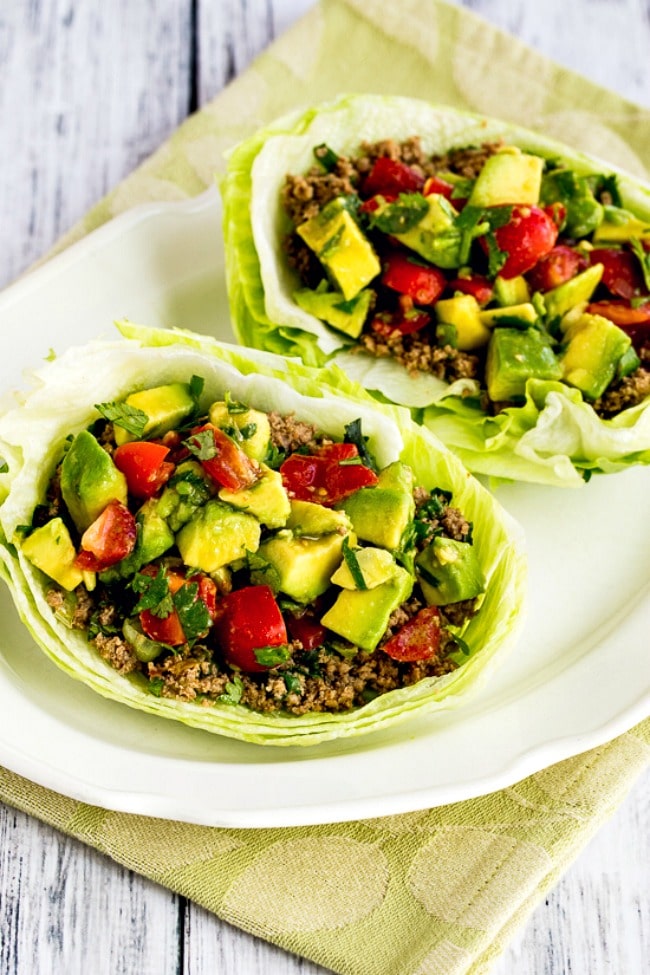 Close-up of assembled lettuce wrap showing turkey filling and garnishes