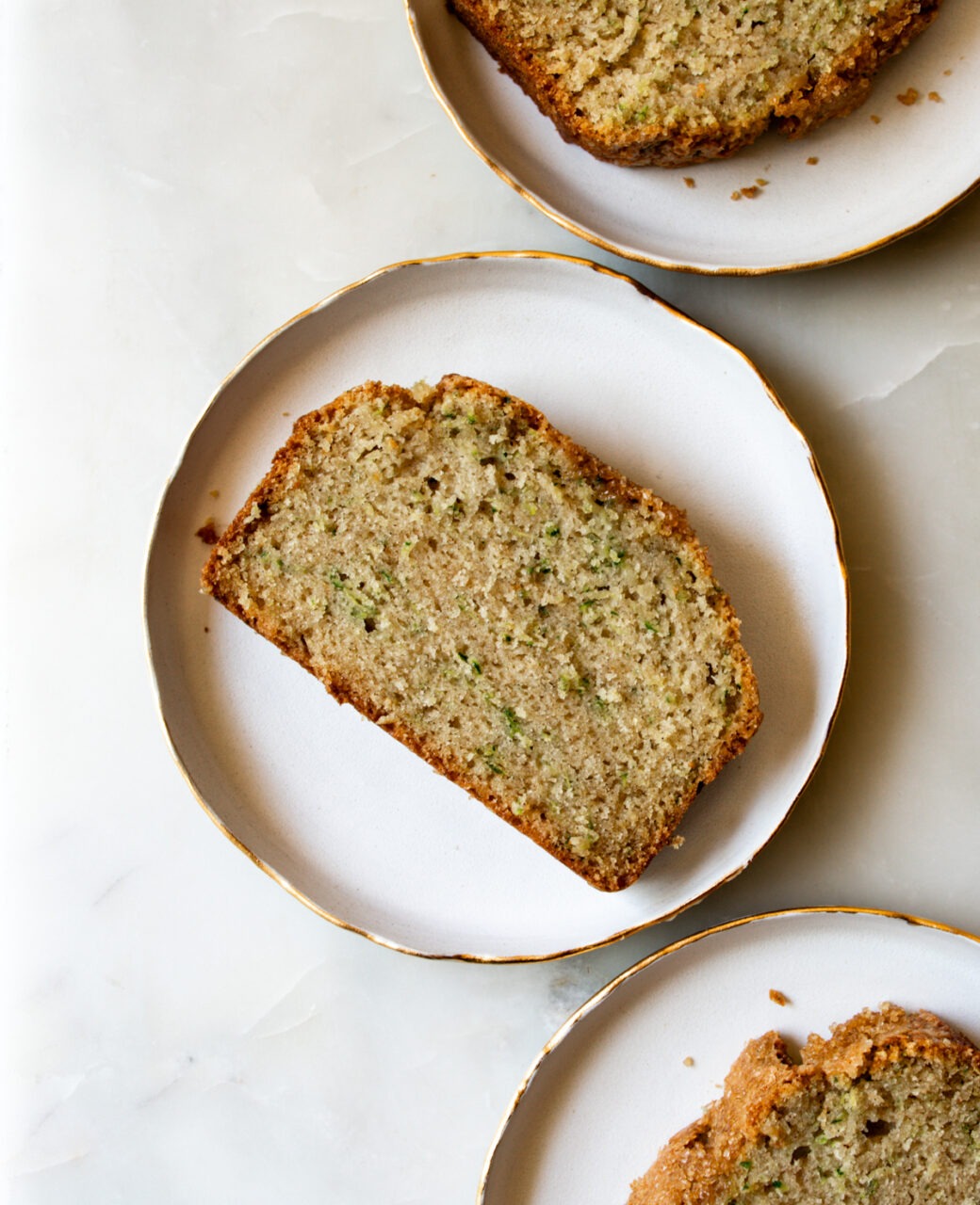 close-up slice of zucchini bread with visible green flecks and tender crumb texture