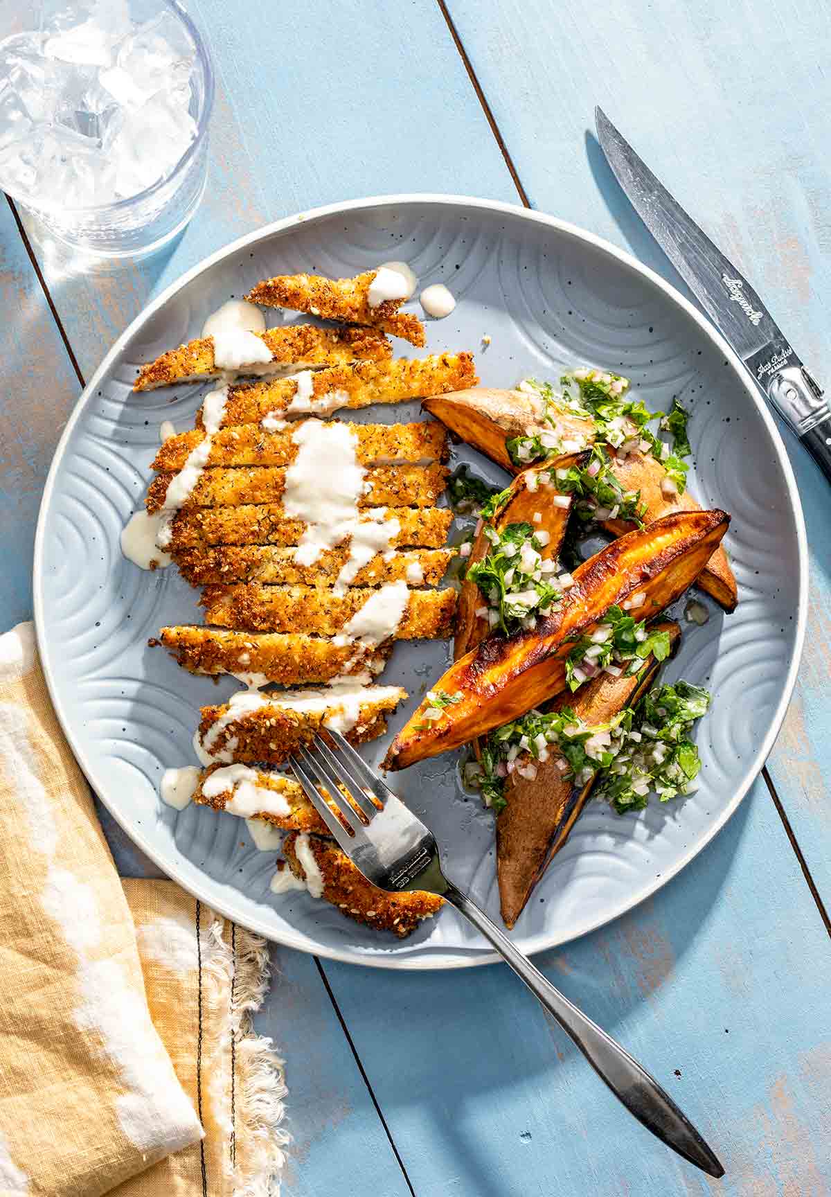 Close-up of golden schnitzel cutlet on a fork showing the crispy coating and juicy interior