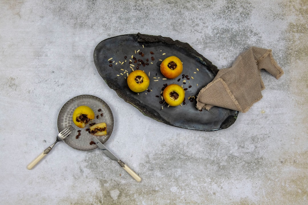 Peach halves on grill pan showing golden caramelization and char marks alongside ingredients setup with burrata and bread slices