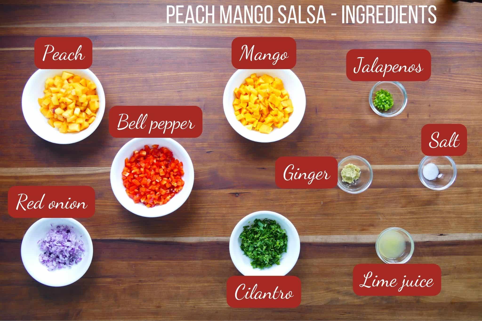 Diced peaches, mango, red onion, jalapeño, cilantro, and lime arranged on a cutting board before mixing — overhead flat lay ingredients shot