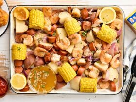 Low Country Shrimp Boil served on a large platter with corn, sausage, potatoes and shrimp garnished with lemon wedges and fresh parsley