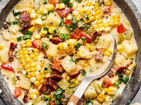 Side-by-side shot of raw corn chowder ingredients — diced potatoes, corn kernels, chopped bacon, onion, garlic, and cream — arranged on a cutting board next to a large pot